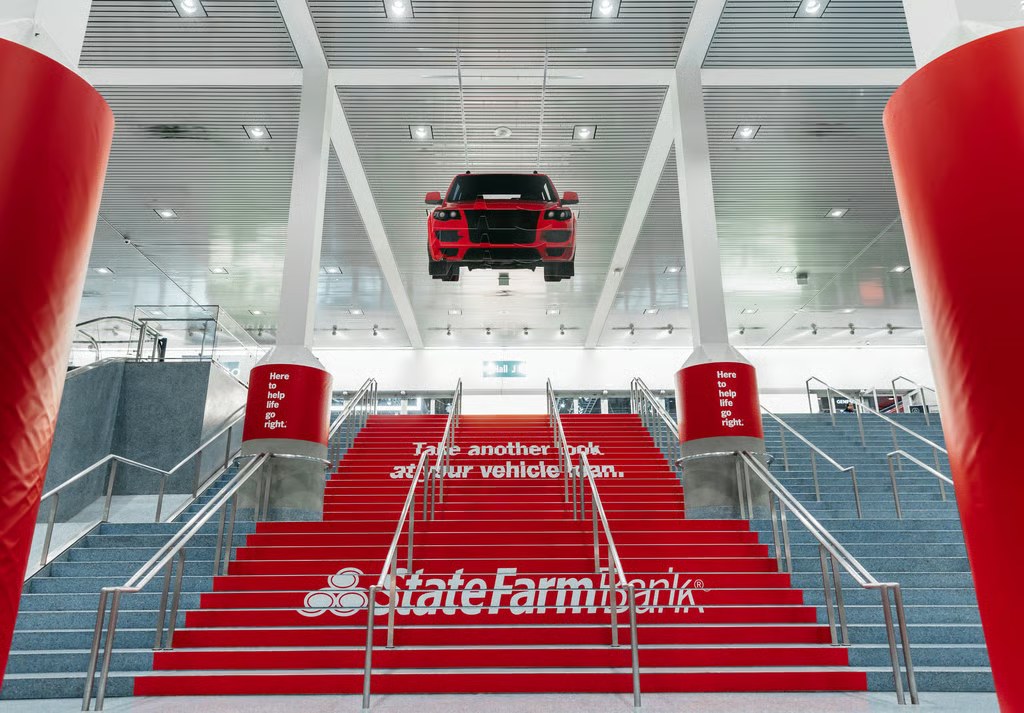 The Convention Center staircase: a car suspended above red steps that read Take another look at your vehicle loan