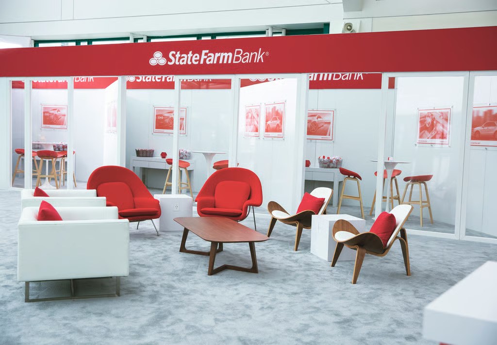 The dealership lounge: red and white chairs in front of glass sales offices