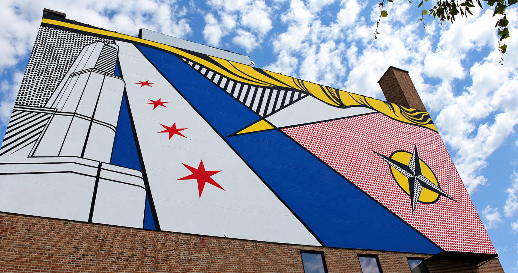 The mural from below: Marina City, the Chicago flag stars and a compass rose in Lichtenstein’s vocabulary